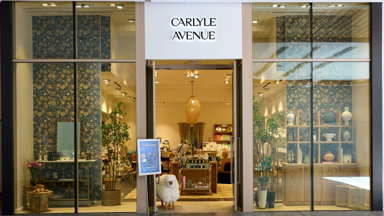 Storefront of Carlyle Avenue with glass doors and interior display.