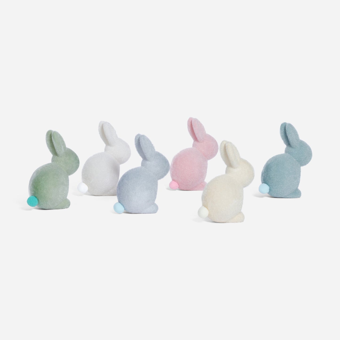 Set of pastel-colored bunny figurines on a white background