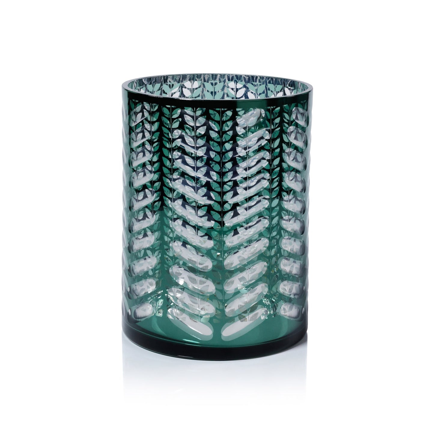 Green glass candle holder with white leaf pattern on a white background