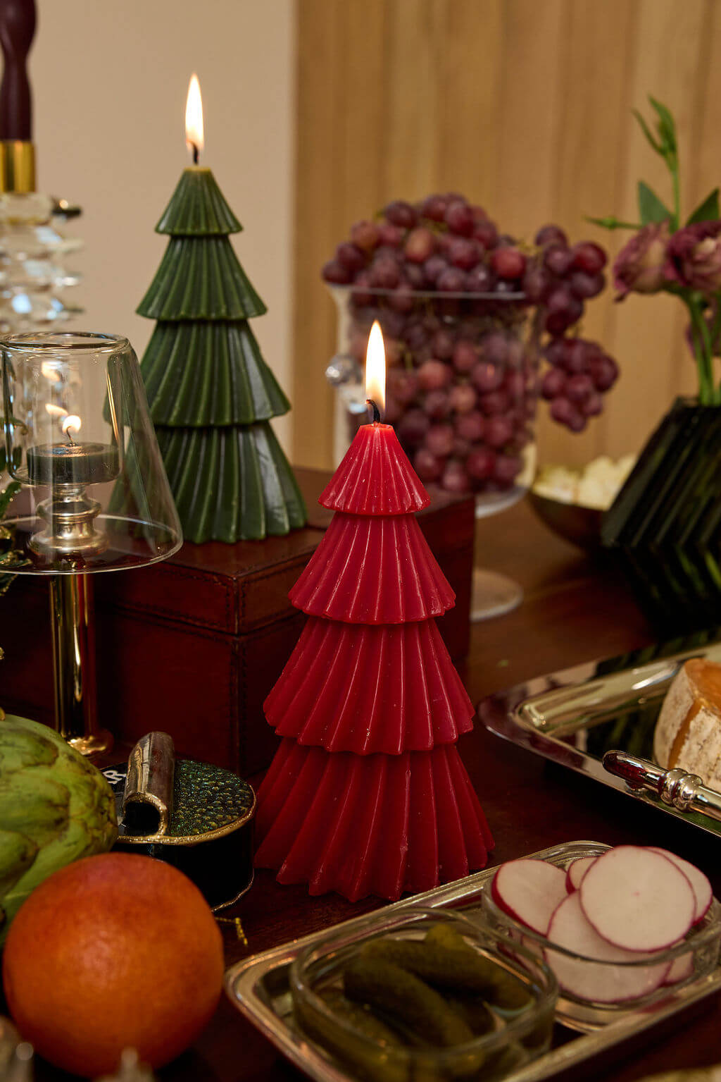 Holiday Candles displayed as decorative tree-shaped candles in festive colors on a holiday table setting.