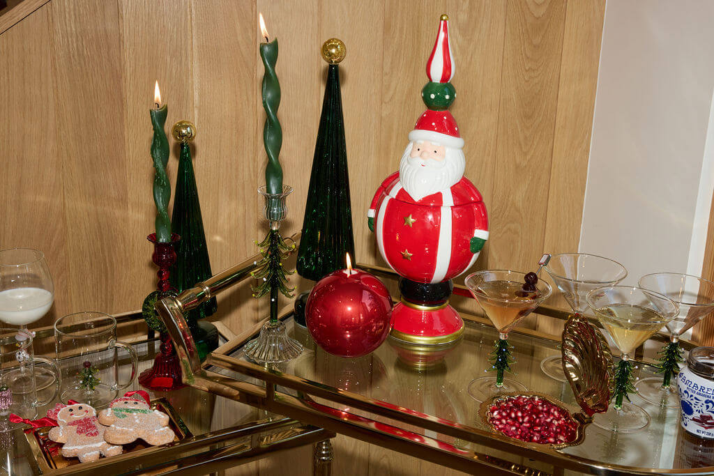 A festive display featuring holiday decor, Santa figure, candles, and cookies for the Christmas in July collection.
