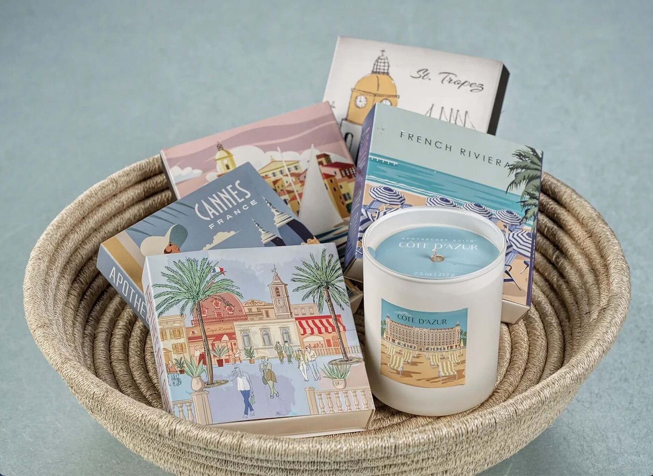 Candle Accessories including elegant candle boxes and a scented candle in a decorative basket.