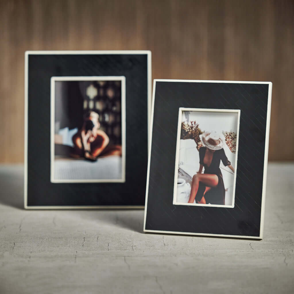 Two elegant picture frames showcasing beautiful photos on a textured surface, perfect for home decor.