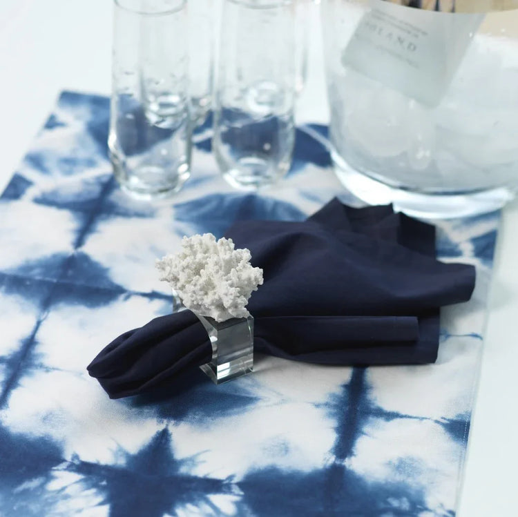 coral napkin ring with blue napkin and tie dye placemat