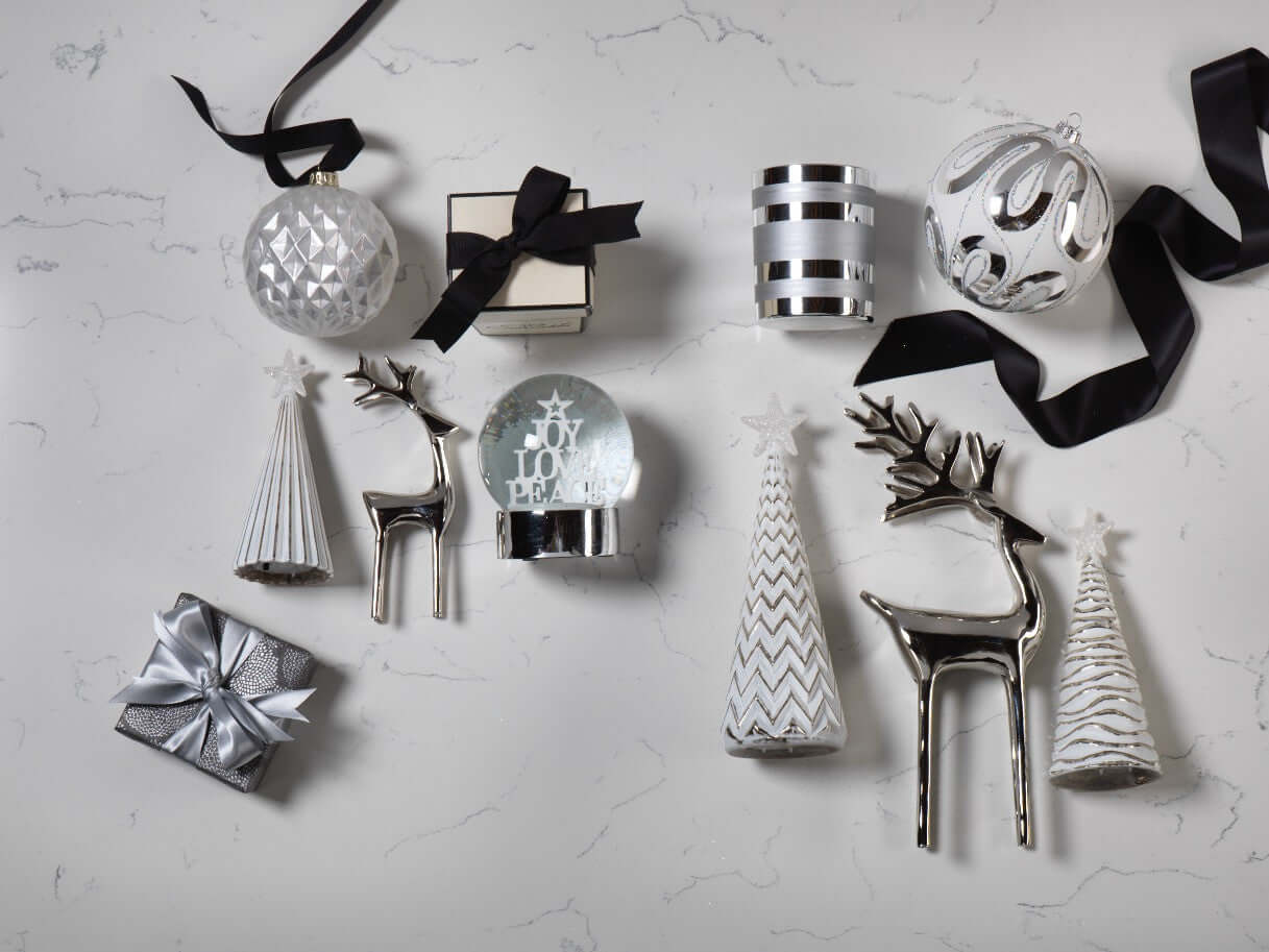 Holiday Collection featuring silver ornaments, decor accents, and gifts, creating a festive and joyful atmosphere.