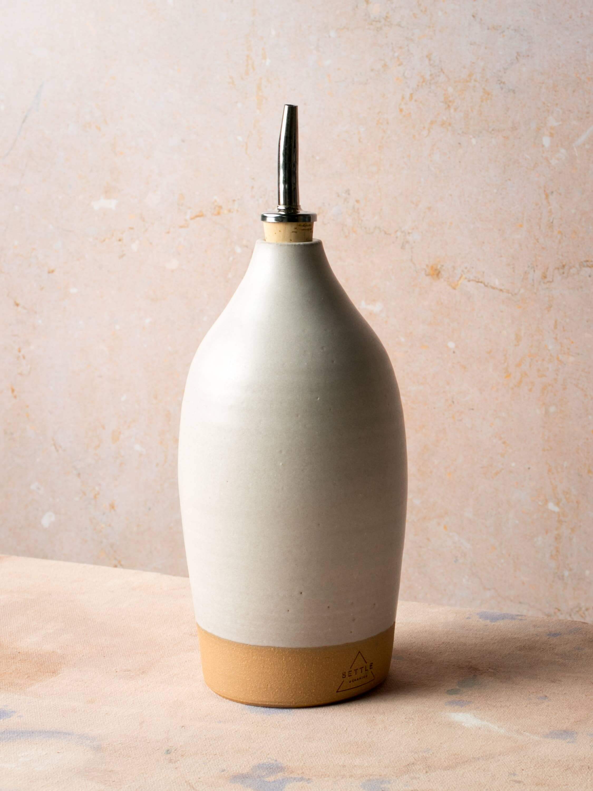 Tall Handmade Ceramic Oil Bottle with polished pourer and matte glaze, perfect for kitchen decor.