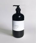 Santal Hand Wash in a black glass bottle with a pump, 16oz/500ml, featuring cedar and sandalwood notes.