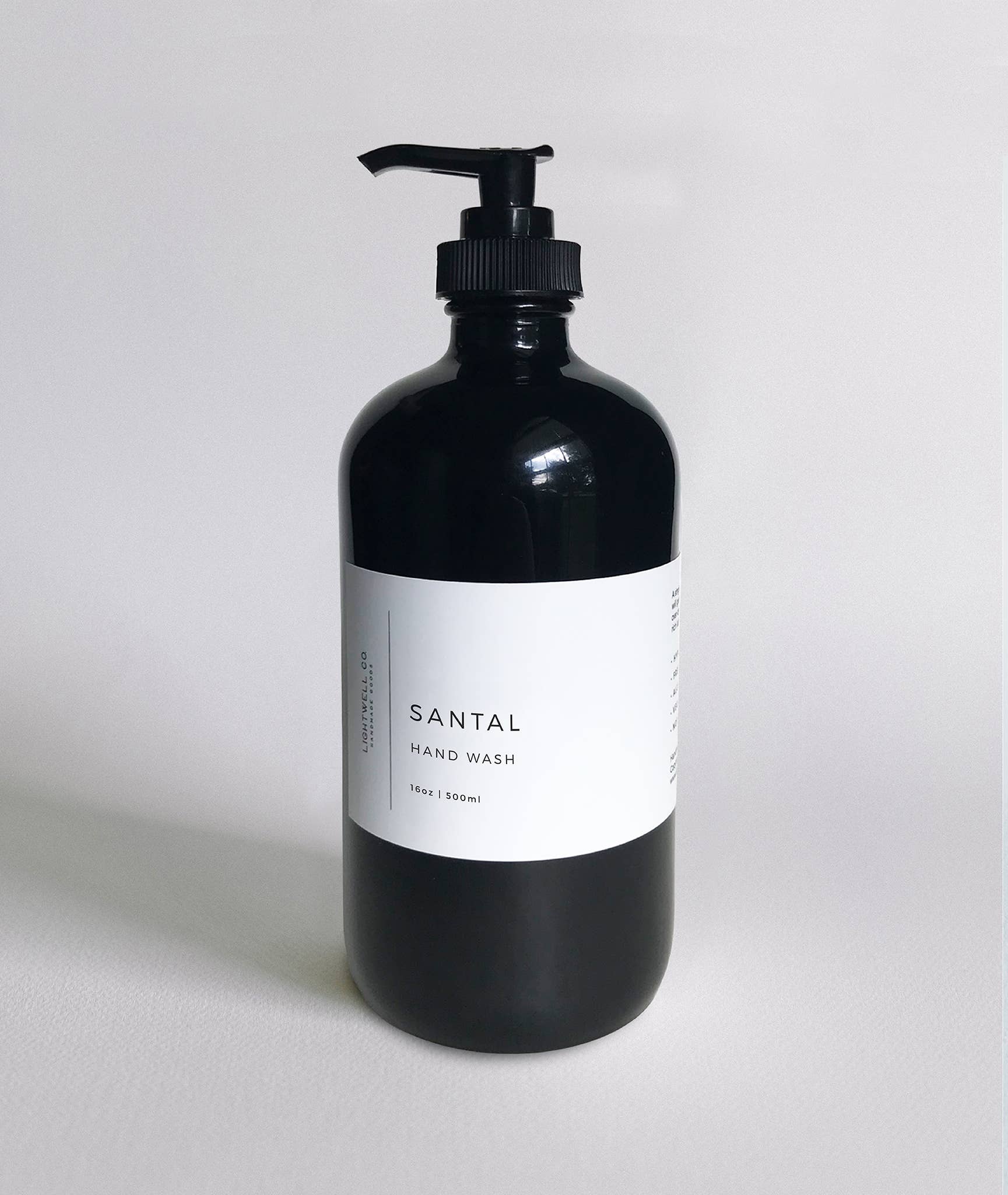 Santal Hand Wash in a black glass bottle with a pump, 16oz/500ml, featuring cedar and sandalwood notes.