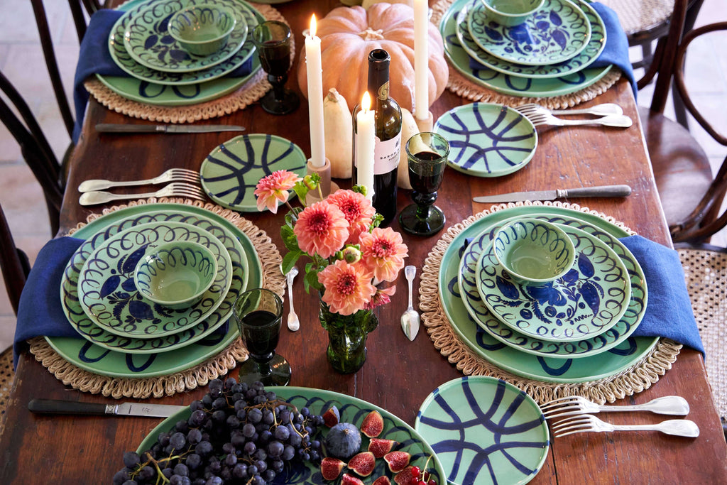 Beautifully arranged Amalfi Dessert Plate Green - 9.1" Diameter on a rustic wooden dining table with seasonal decor.