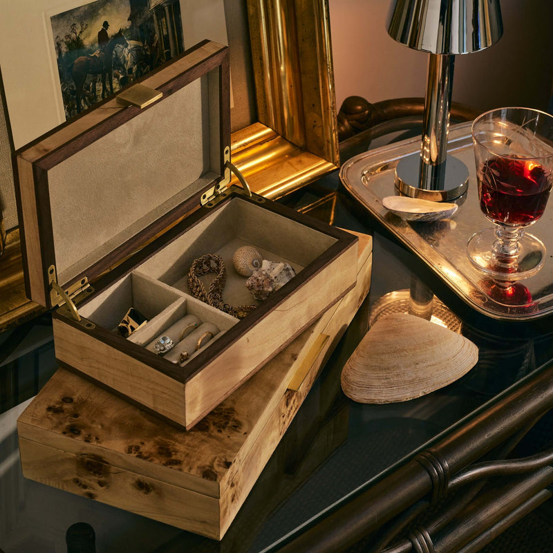 Linea Heritage Burl Veneer Jewelry Box with suede-lined interior displayed on a table with decorative items.