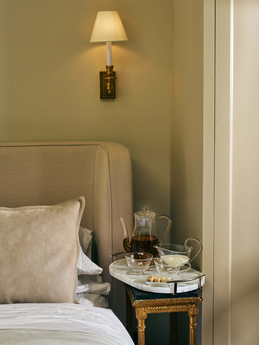 Luze Oval Marble Tray adorned with tea and snacks beside a cozy bed, featuring elegant decor and gentle lighting.
