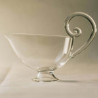Clear sauciere with decorative handle for serving sauces, 5”H x 7”W, 6 FL OZ / 175 ML.