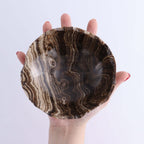 Mexican Onyx/Calcite Bowl OOAK held in hand showcasing its unique patterns and natural beauty.