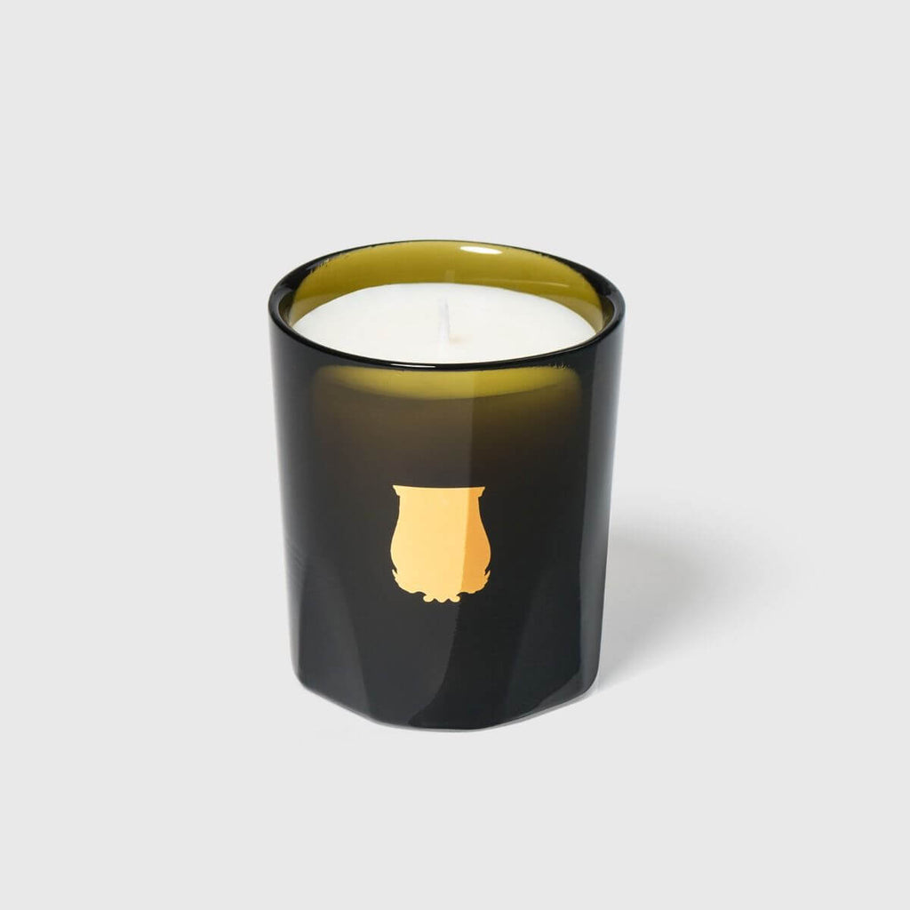Odalisque Petite Candle in a sleek black glass holder with gold accent, showcasing its elegant design and fragrance.