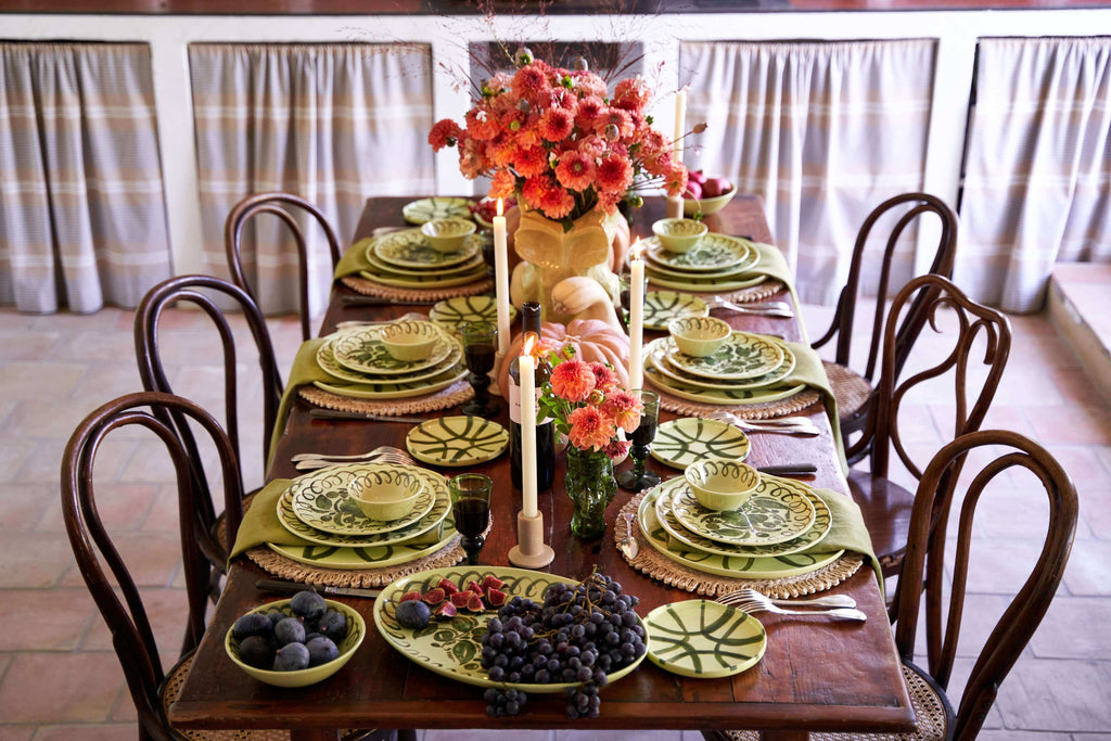 Amalfi Dessert Plate Lime - 9.1" Diameter displayed on a beautifully set dining table with fruits and flowers.