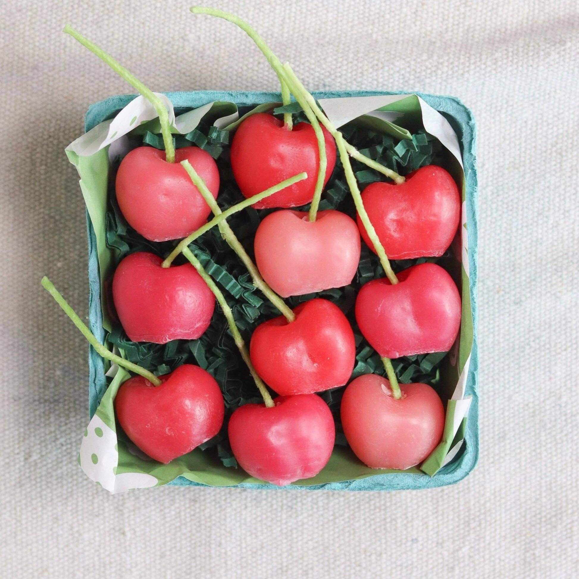 Pink Cherry Birthday Beeswax Candles arranged in green container with decorative paper.
