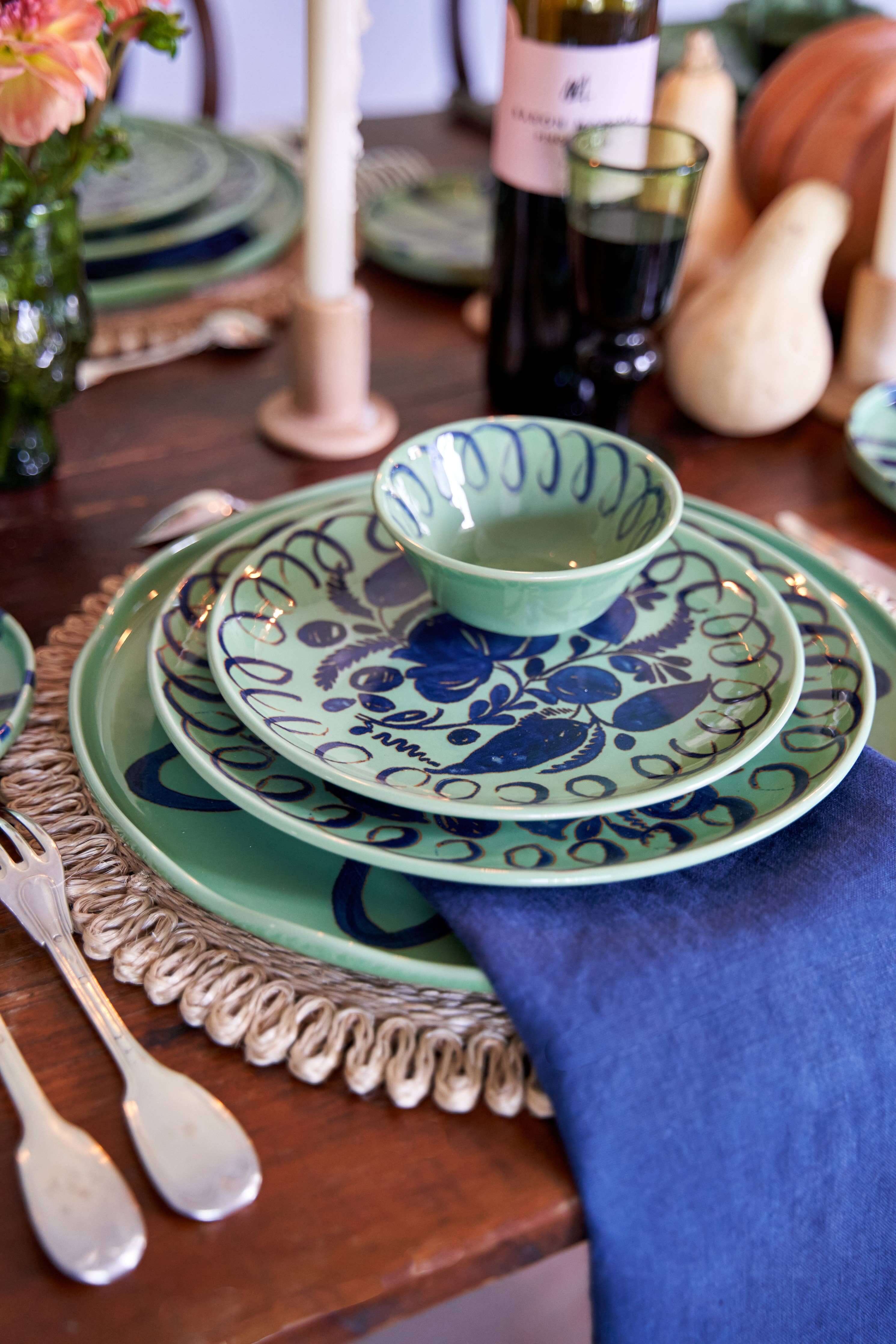 Amalfi Dessert Plate Green - 9.1" Diameter with blue patterned bowl and napkin on a rustic table setting.