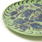 La Terrazza Ceramic Dinnerware featuring a hand-painted floral design on a green plate.