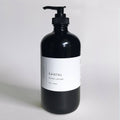Santal Hand Lotion in a black glass bottle, 16oz/500ml, featuring a waterproof label for hydration and nourishment.