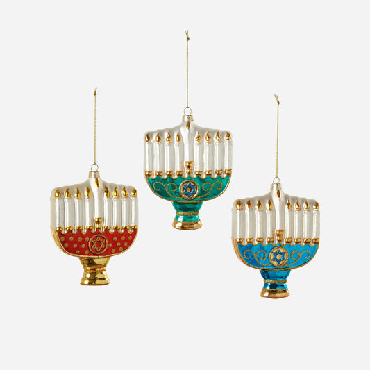 Three colorful Menorah ornaments hanging against a white background