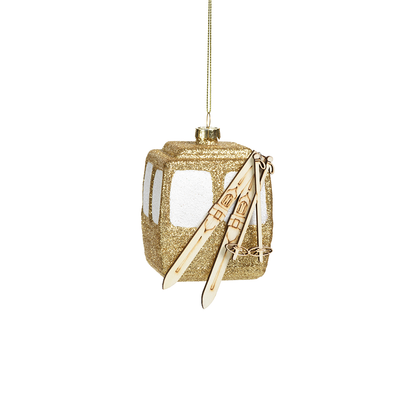 Gold glittery lantern-shaped ornament with a white card inside on a white background
