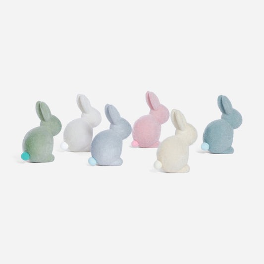 Set of pastel-colored bunny figurines on a white background