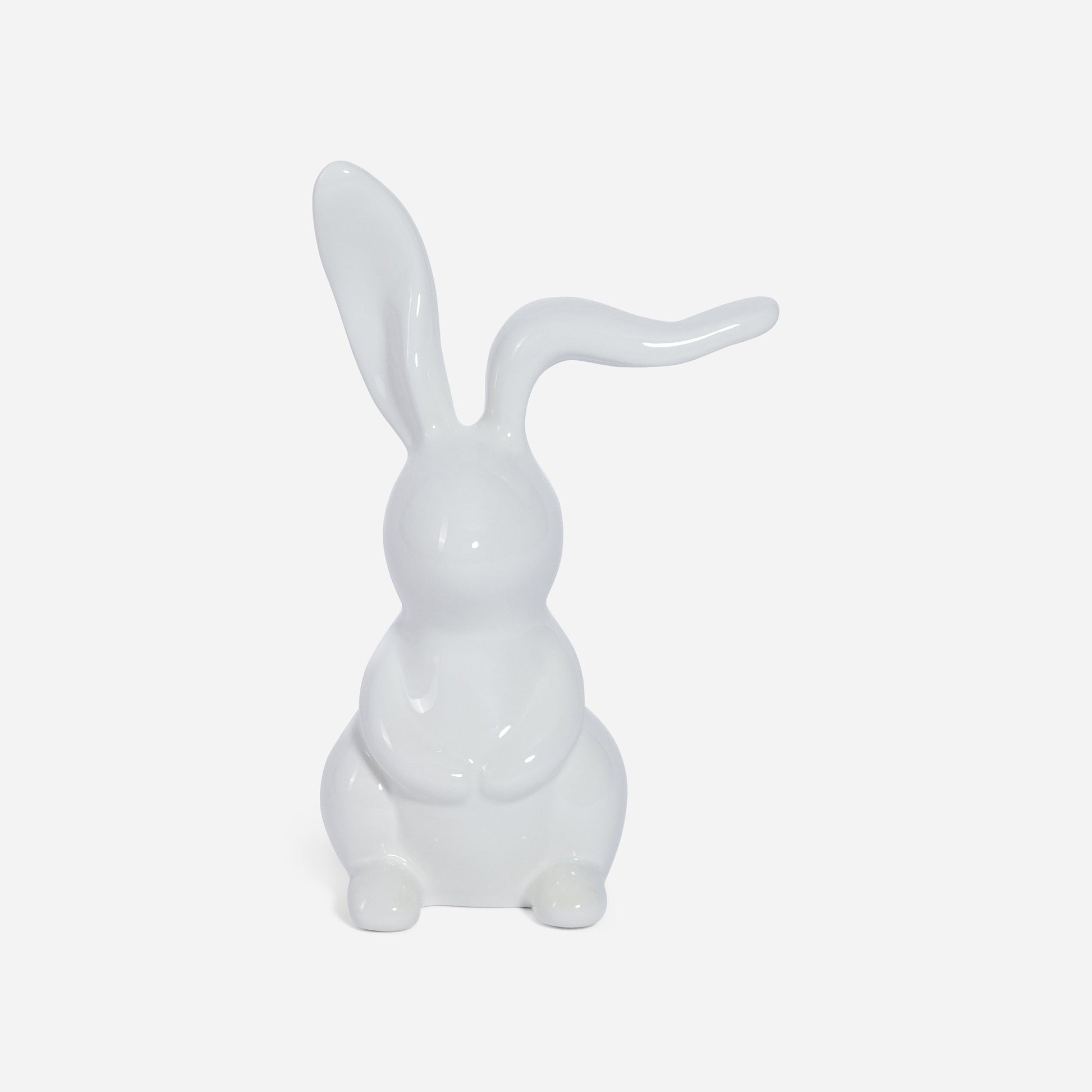 White ceramic rabbit sculpture on a light gray background