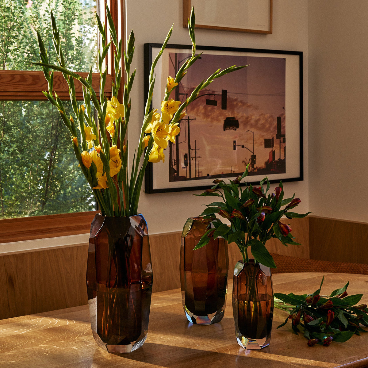 amber vases with flowers in them