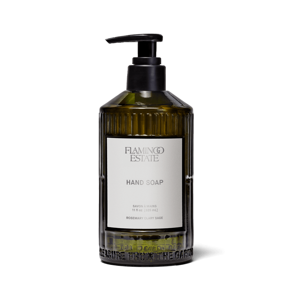 Flamingo Estate Rosemary Clary Sage Glass Hand Soap in translucent green glass bottle with pump.