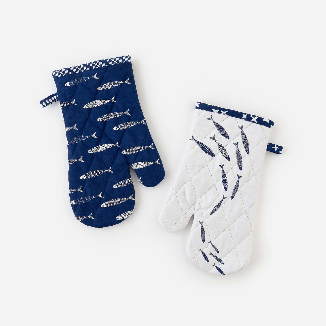 Set of two assorted fish-themed quilted oven mitts for cooking and baking.
