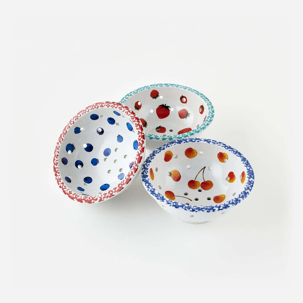 Set of 3 Assorted Berry Bowls in vibrant colors with fruit designs and perforated surfaces for easy drainage.