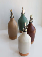 Tall Handmade Ceramic Oil Bottle set of four in different colors with polished pourers.
