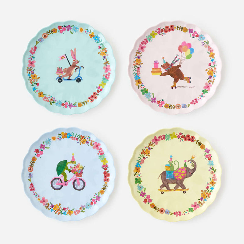 Set of four party plates with colorful animal birthday illustrations.