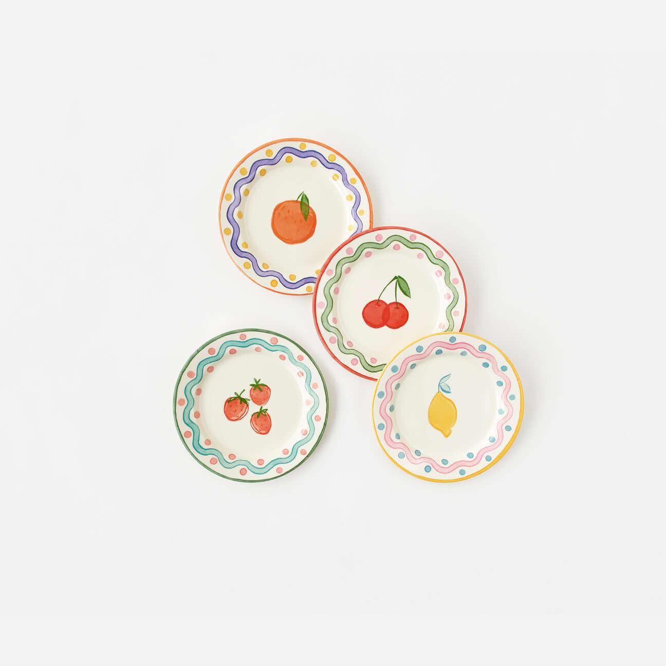 Terrazzo "Enamel" Fruit Plate, Set of 4 in colorful designs featuring fruits like orange, cherries, strawberries, and lemon.