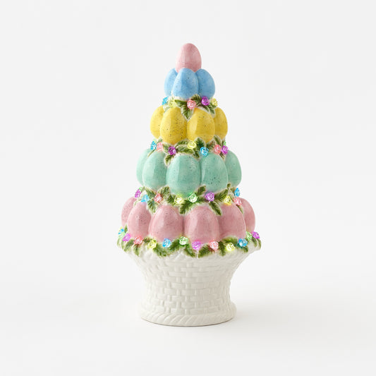 Decorative cake-shaped vase with pastel colors on a white background