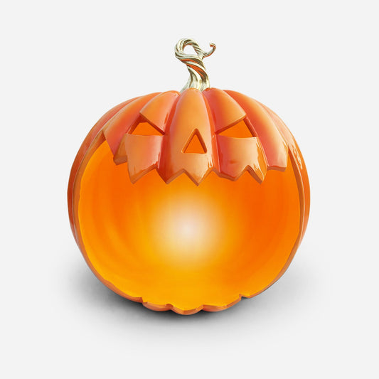 Decorative pumpkin with a carved face on a light gray background