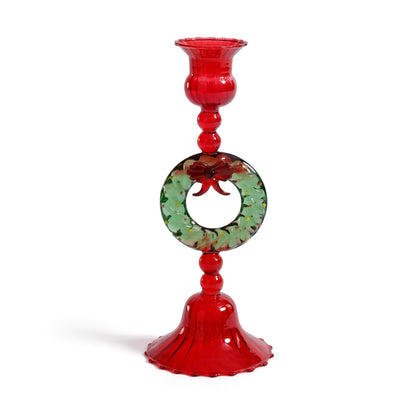 Decorative red glass candle holder with floral design on a white background