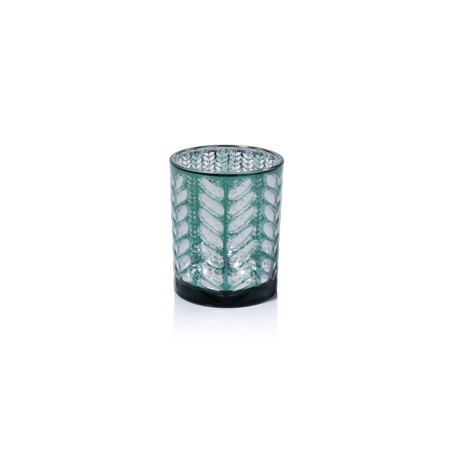 Decorative glass candle holder with leaf pattern on a white background