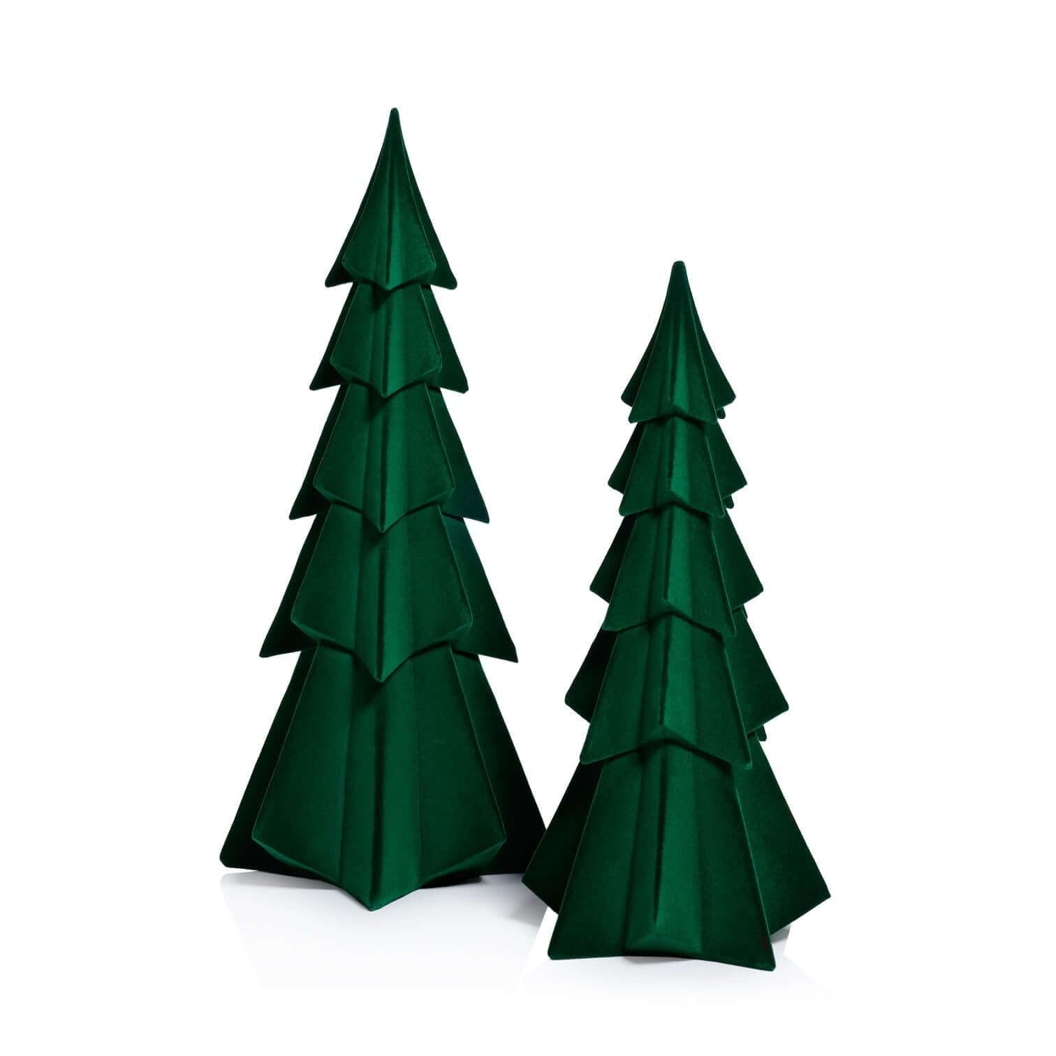 Two green paper Christmas trees on a white background