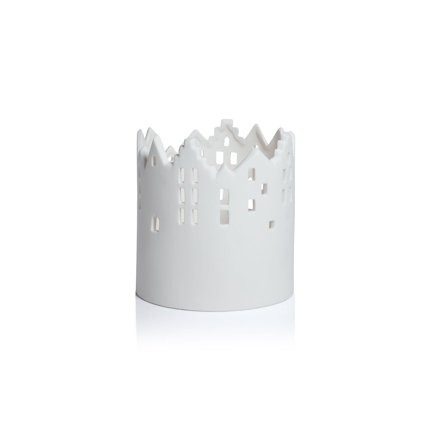 White decorative candle holder with cut-out design on a white background