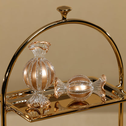 Gold tray with decorative glass items on a beige background