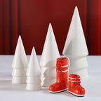 Après Ski Boots, Set of 6 Assorted decorative red ski boot ornaments next to white Christmas trees.