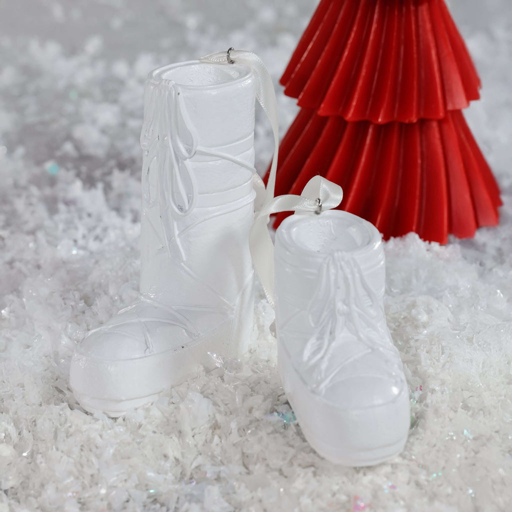 Après Ski Boots, Set of 6 Assorted white holiday ornaments on snow backdrop.