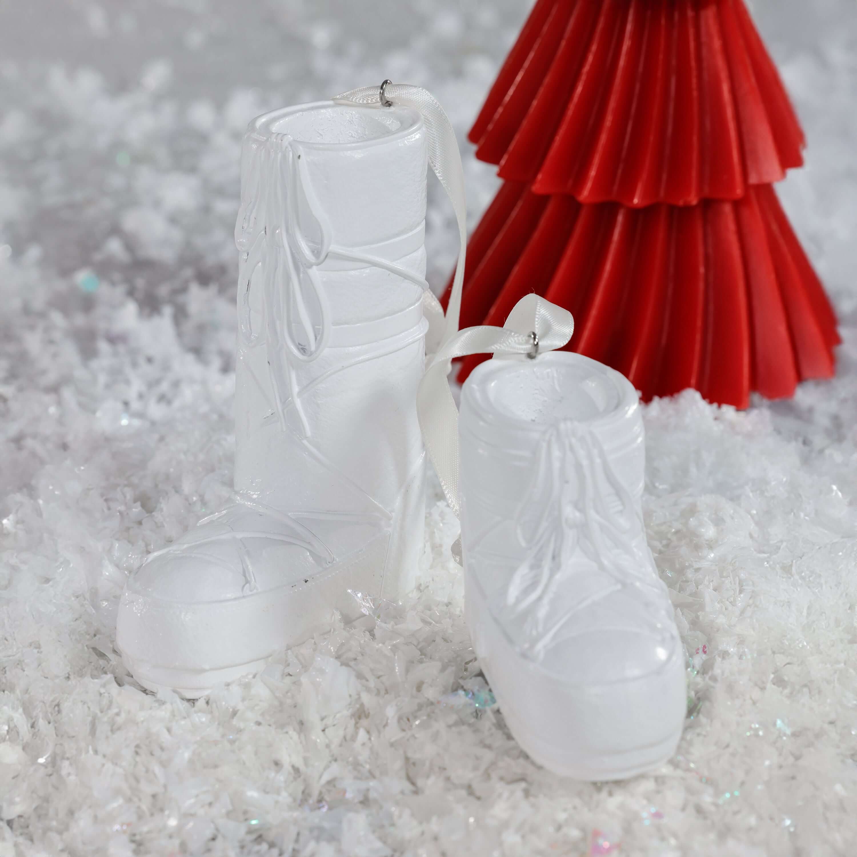 Après Ski Boots, Set of 6 Assorted white holiday ornaments on snow backdrop.