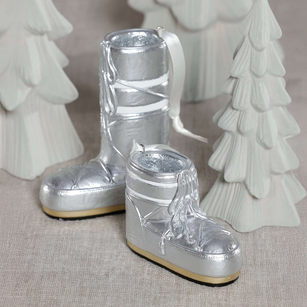 Après Ski Boots, Set of 6 Assorted silver holiday ornaments on a festive display.