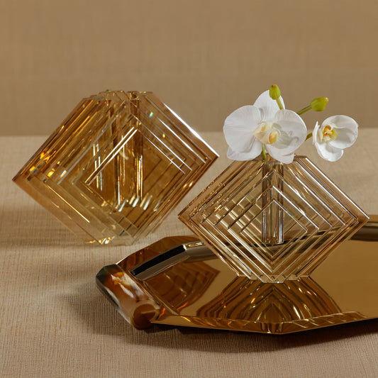Decorative glass pieces with a geometric design on a beige surface