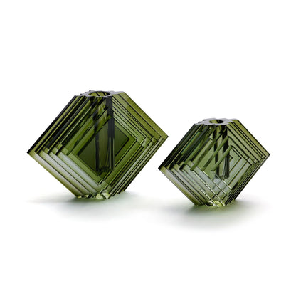 Two green geometric vases on a white background