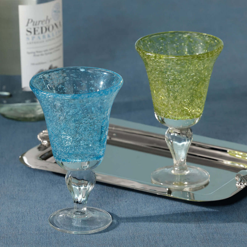 Antibes Wine Glass, Set of 4 displayed with blue and green mouth-blown designs on a silver tray.