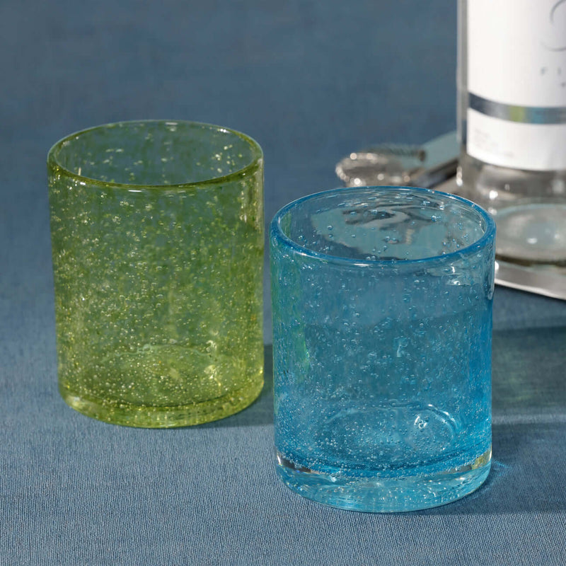 Antibes Glass Tumbler, Set of 4 in aqua and chartreuse, showcasing mouth-blown seeded glass design.