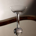 Elegant cocktail glass from the Madrid Glassware Collection showcasing a sculptural sphere base.